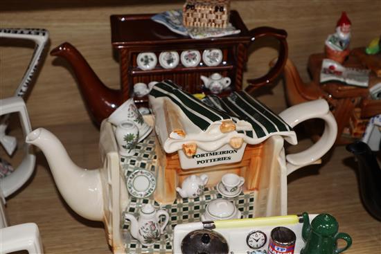 A collection of thirteen Portmeirion and Cardew novelty teapots, including dresser, sewing machine and kitchen range examples